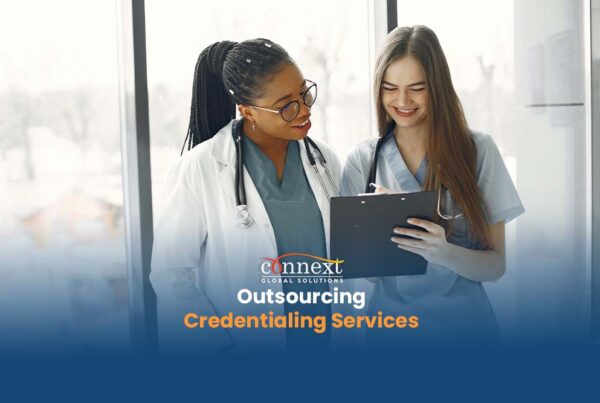 Outsourcing-Credentialing-Services-doctor-and-nurse-wearing-scrub-suit-reviewing-patient-records-in-hospital-1@1x_1