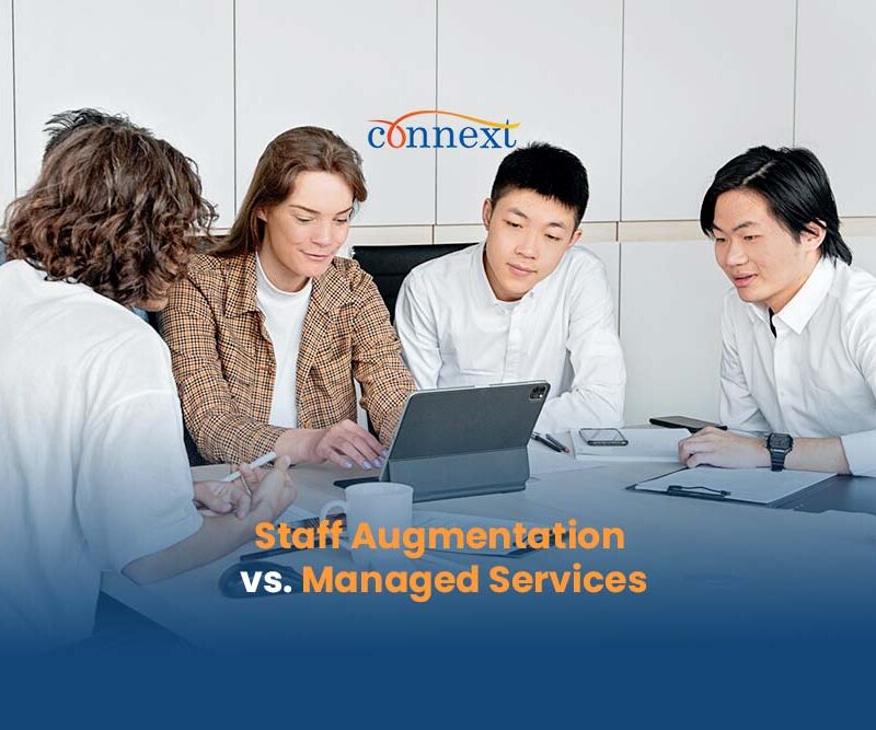 Staff-Augmentation-vs.-Managed-Services-5-people-asian-causasian-in-a-meeting-using-laptop-inside-office