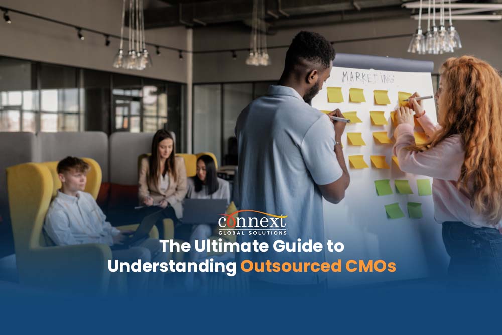 The Ultimate Guide to Understanding Outsourced CMOs People in corporate attire brainstorming using whiteboard in office