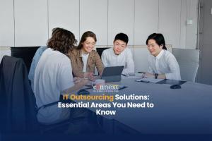 IT Outsourcing Solutions Essential Areas You Need to Know team meeting caucasian asian in corporate attire in office with tablet