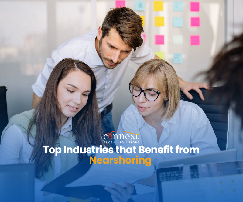 Top-industries-that-benefit-from-Nearshoring-services-latin-american-caucasian-man-and-women-in-corporate-attire-having-a-meeting-at-the-office