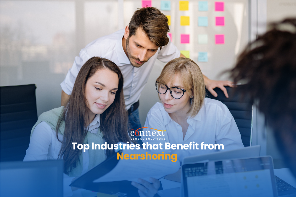 Top-industries-that-benefit-from-Nearshoring-services-latin-american-caucasian-man-and-women-in-corporate-attire-having-a-meeting-at-the-office