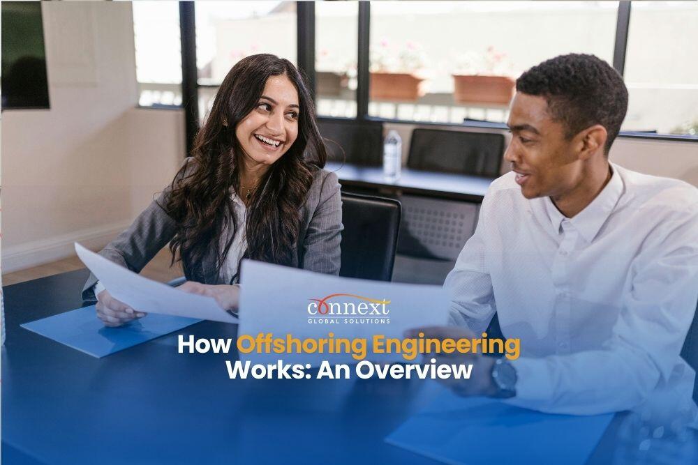 woman-in-gray-blazer-holding-white-paper-sitting-beside-man-in-white-long-sleeve-shirt How Offshoring Engineering Works An Overview