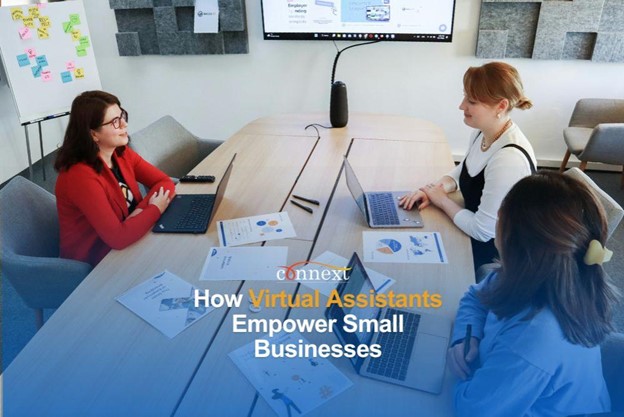 How Virtual Assistants Empower Small Businesses women working in conference room with laptop and papers