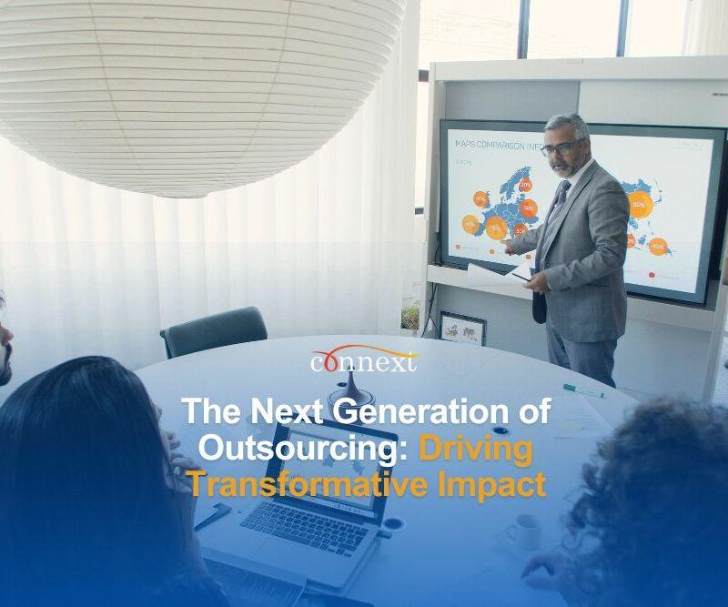 The Next Generation of Outsourcing: Driving Transformative Impact man presenting in a conference room meeting full of people