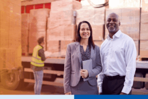 supply chain professionals smiling while holding a tablet