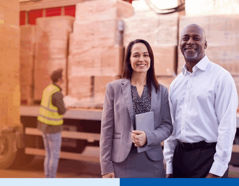 supply chain professionals smiling while holding a tablet