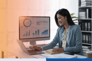 Businesswoman sits at work with laptop and computer and analyzes corporate and data activities 