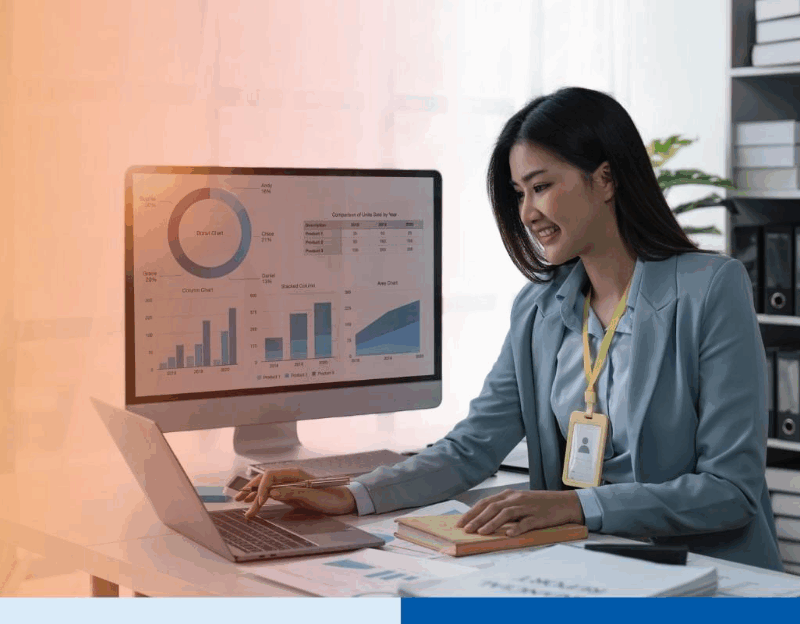 Businesswoman sits at work with laptop and computer and analyzes corporate and data activities 