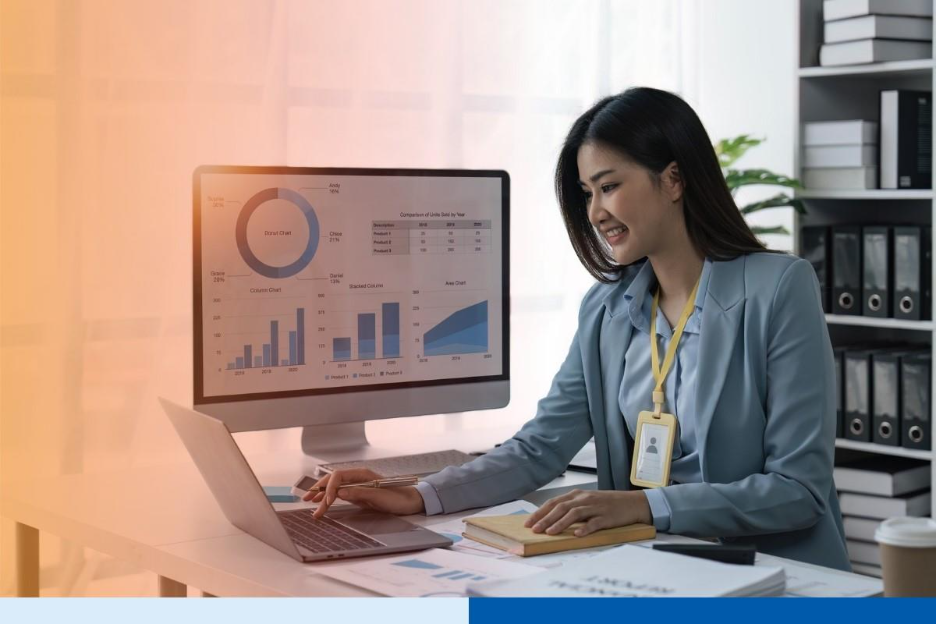 Businesswoman sits at work with laptop and computer and analyzes corporate and data activities 