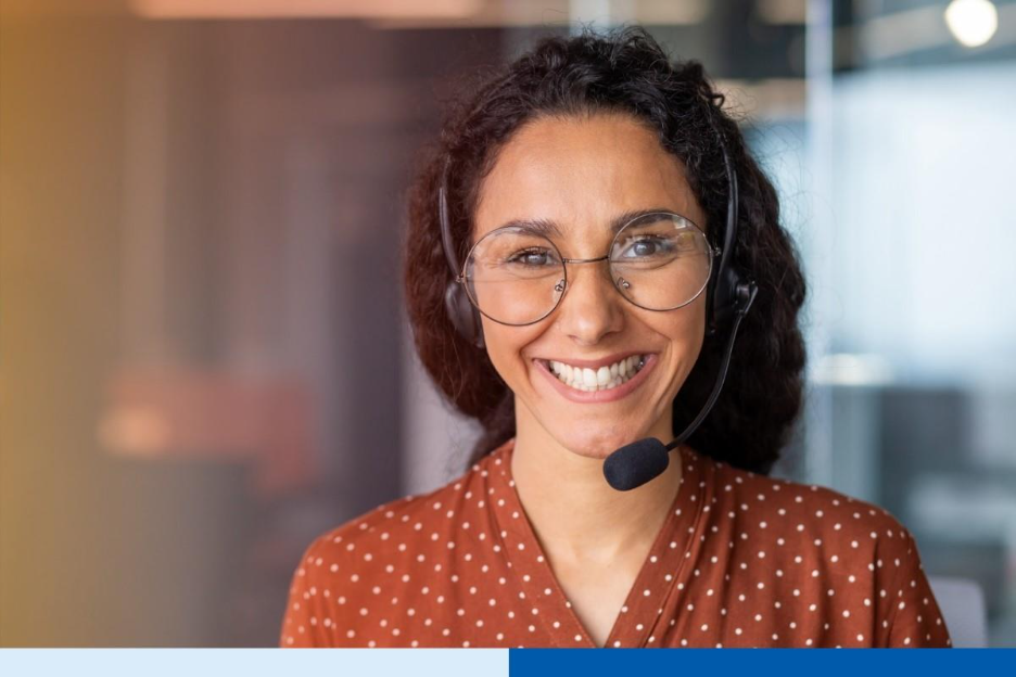 smiling latina woman wearing glasses and a headset, looking friendly and approachable