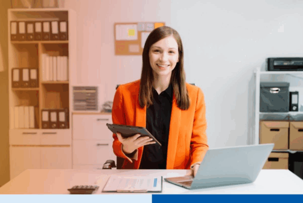 business woman using tablet and laptop for doing math finance on an office desk, tax