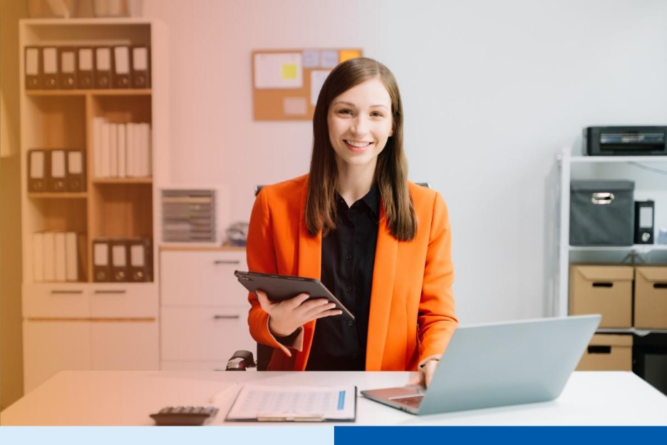 business woman using tablet and laptop for doing math finance on an office desk, tax