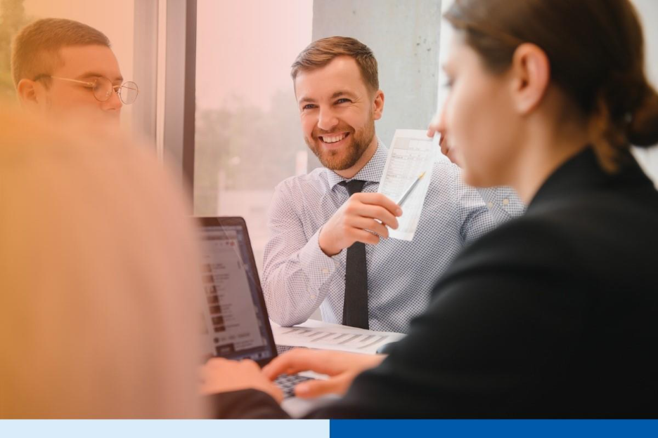 man holding a receipt wearing corporate attire smiling in office in office setting meeting