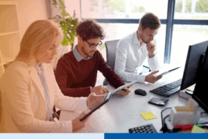 group-of-corporate-professionals-using-tablets-in-office