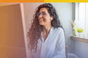 Smiling professional reviewing content online—illustrating the people behind content moderation outsourcing in a trusted, remote work environment.