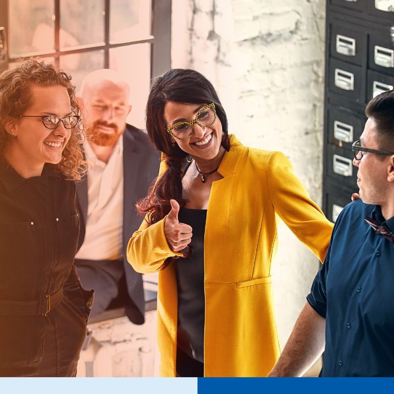 Beautiful business people are using gadgets, talking and smiling during the conference in office