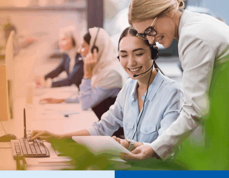 selective focus of smiling multicultural businesswomen using tablet together at workplace in office