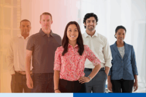 An office in the city. Business team multi ethnic group, men and women standing together in a group.