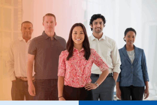 An office in the city. Business team multi ethnic group, men and women standing together in a group.