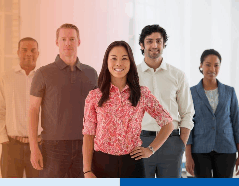 An office in the city. Business team multi ethnic group, men and women standing together in a group.
