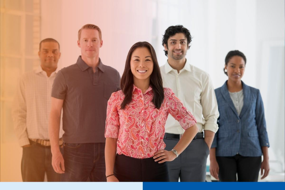 An office in the city. Business team multi ethnic group, men and women standing together in a group.