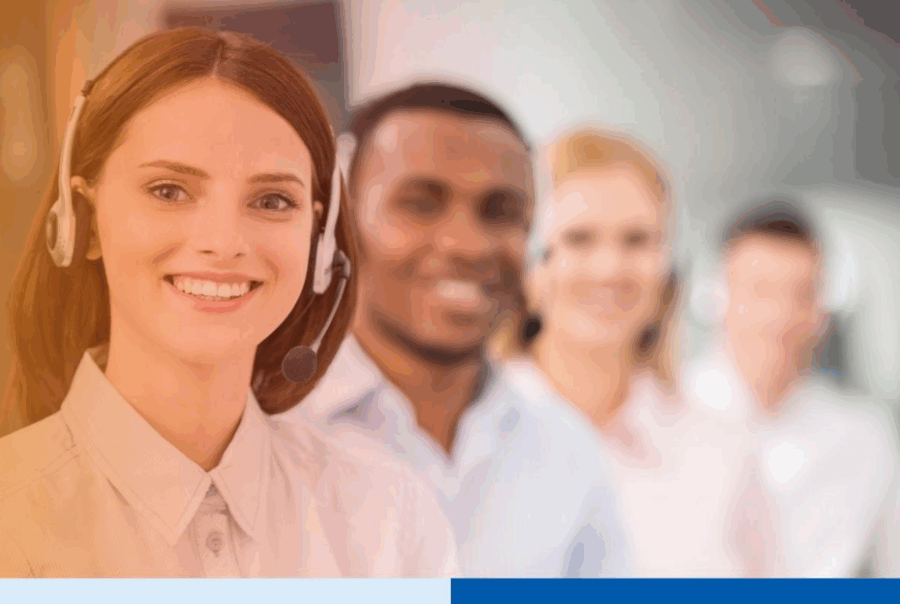 Similing woman wearing headset in a call centerÂ