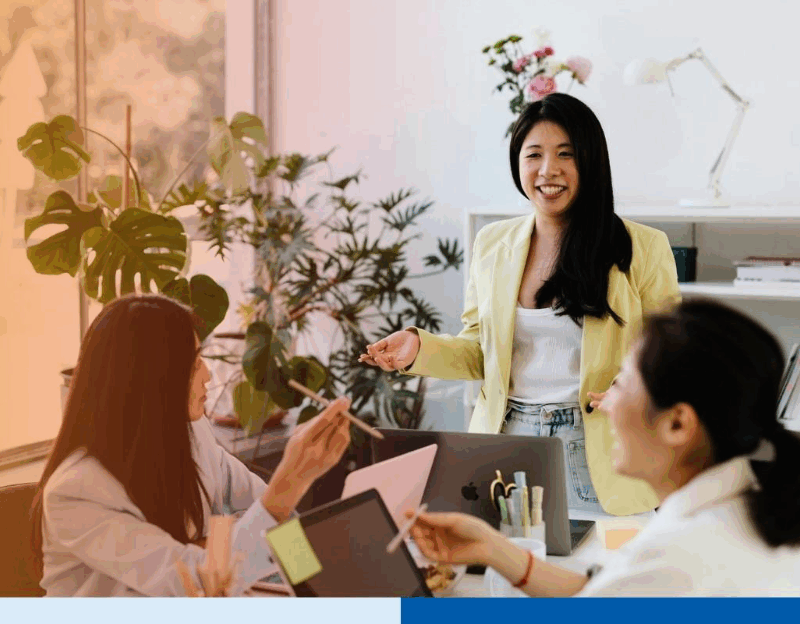 Asian Woman Talking to Her Colleagues in a Meeting 