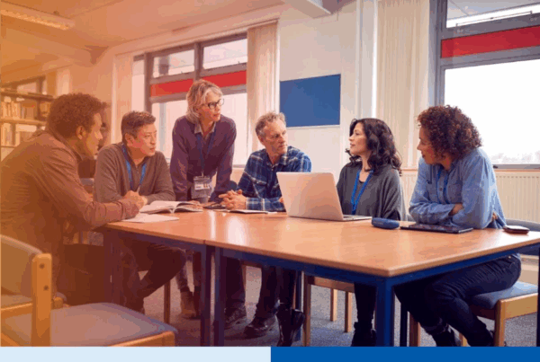 Diverse business team in a meeting discussing project strategy with a laptop in an office setting 