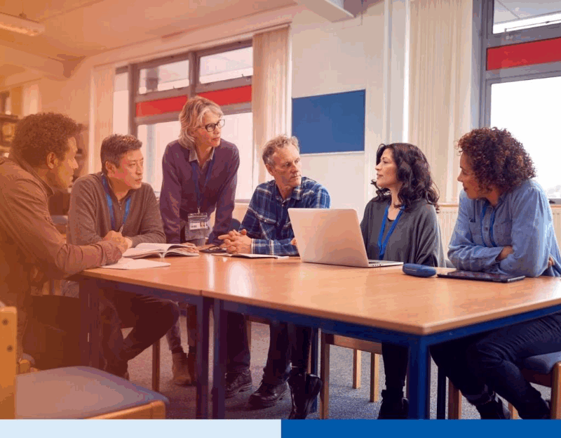 Diverse business team in a meeting discussing project strategy with a laptop in an office setting 