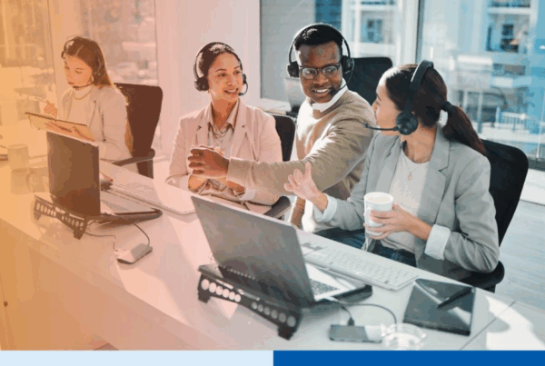 A diverse team of BPO professionals with headsets collaborating in a modern office, illustrating a smooth transition after switching BPO vendors.