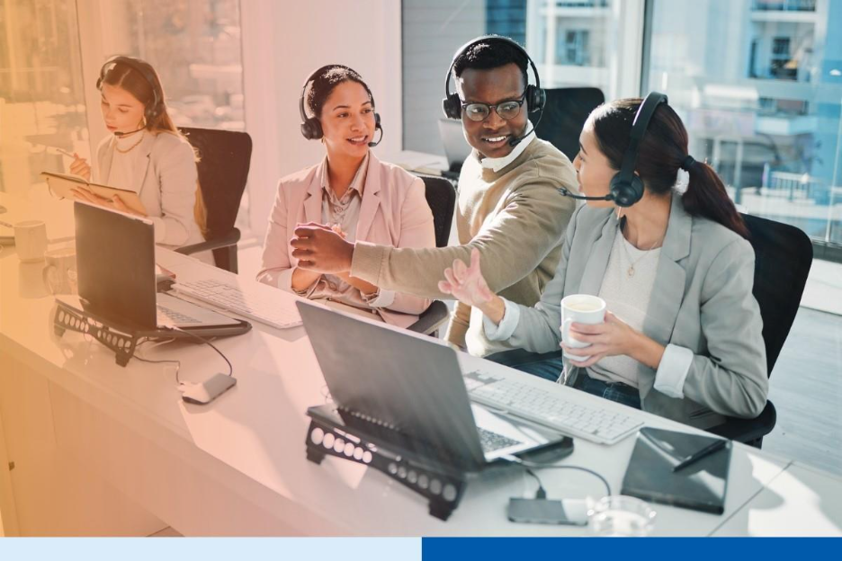 A diverse team of BPO professionals with headsets collaborating in a modern office, illustrating a smooth transition after switching BPO vendors.