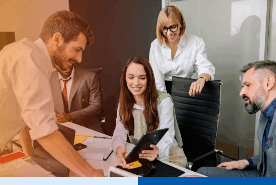 Group of business professionals discussing documents and digital devices in a modern office meeting, representing collaboration during the BPO switching process.