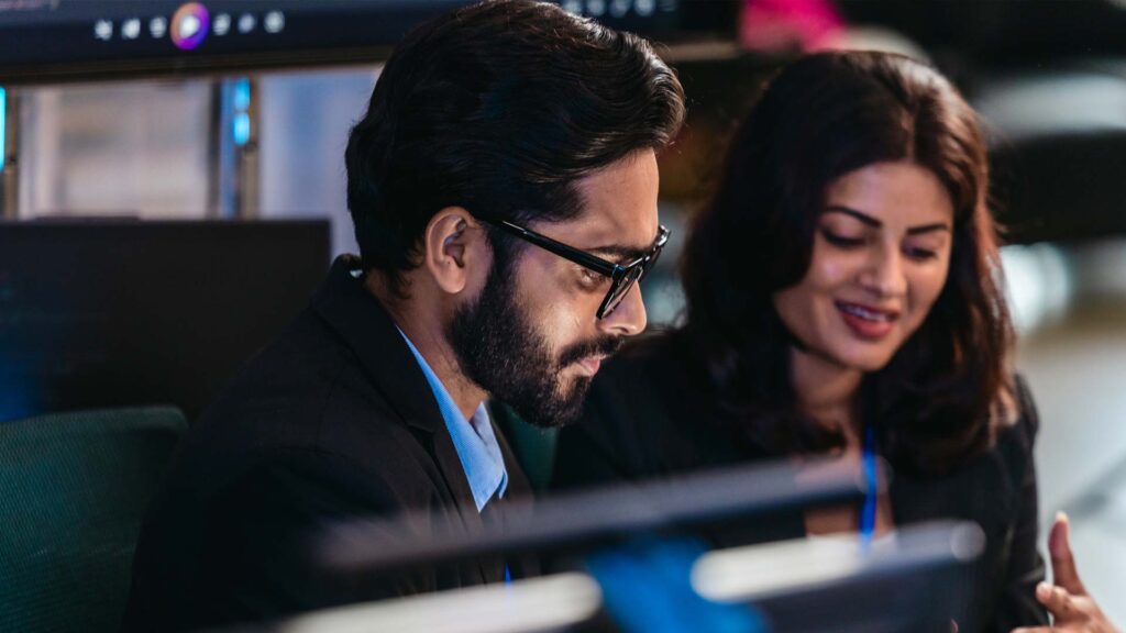 Two software developers from India discussing work and IT tasks