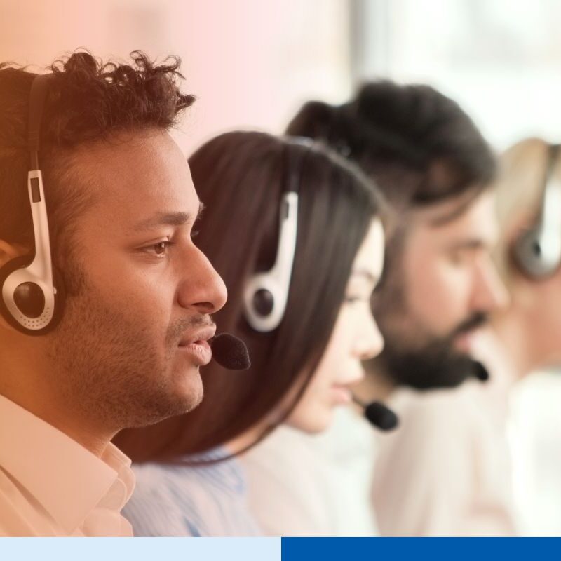 Group of call center agents making calls and working on their computers