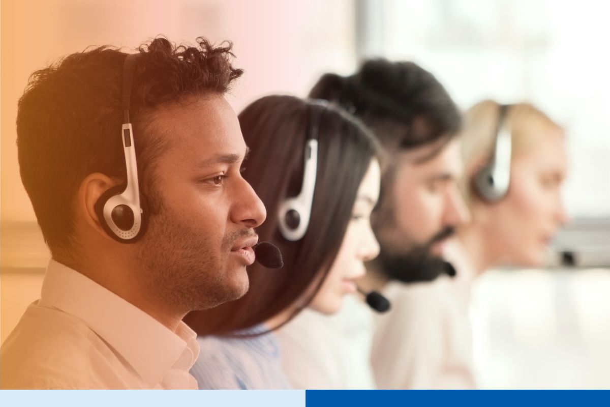 Group of call center agents making calls and working on their computers