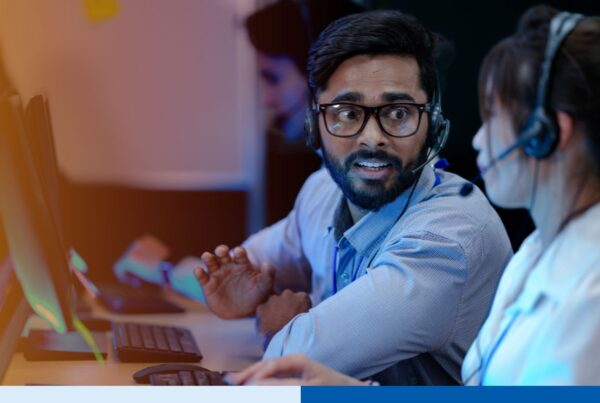 Two customer support employees in India are collaborating for a project