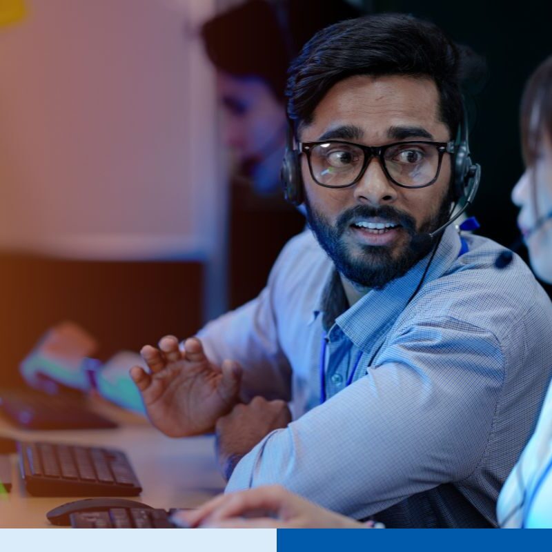 Two customer support employees in India are collaborating for a project