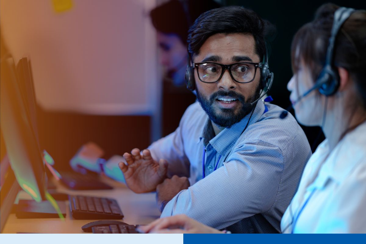 Two customer support employees in India are collaborating for a project