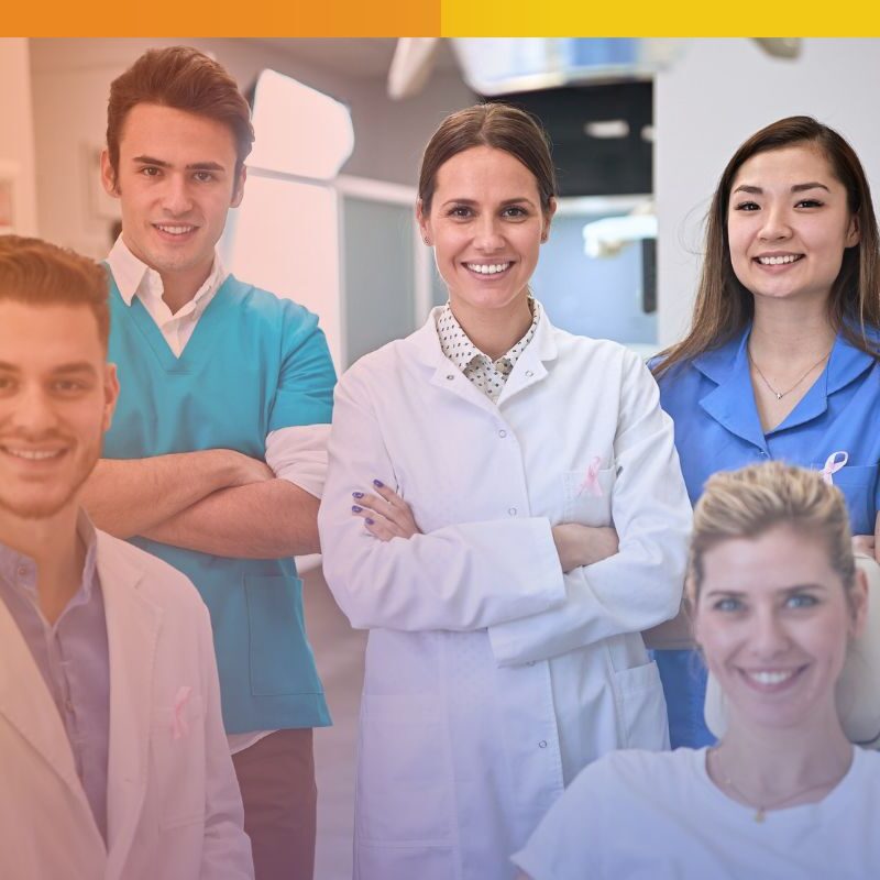 A diverse team of five smiling healthcare professionals in a clinical setting