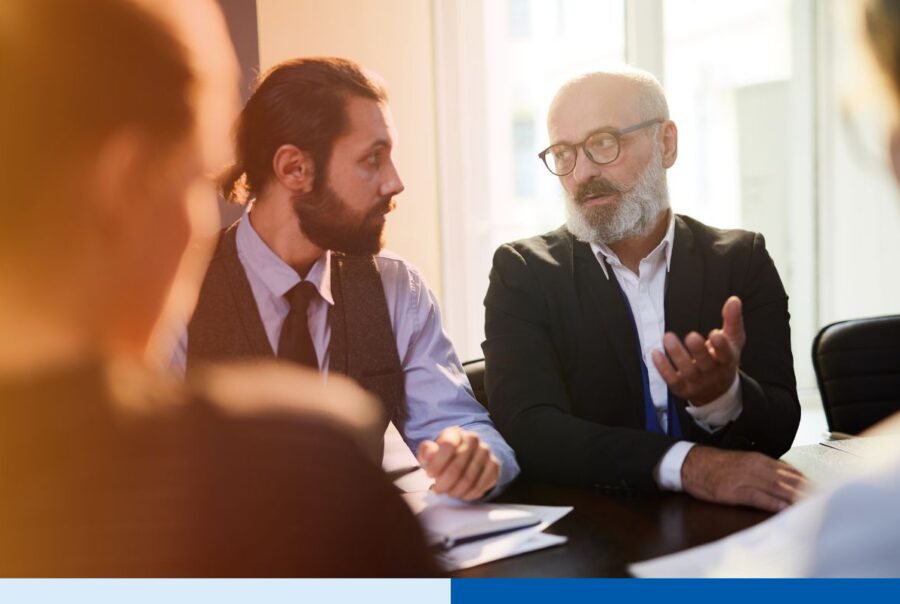 A group of PE firms leaders reading a company org chart before offshoring talents