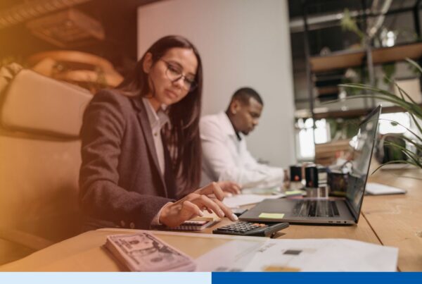 Offshore accounting professional processing accounts payable invoices on a laptop in a finance office