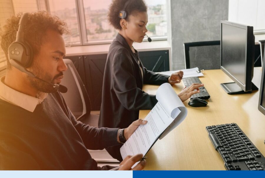 Payroll outsourcing professionals analyzing payroll data and employee compensation records in a finance operations office.
