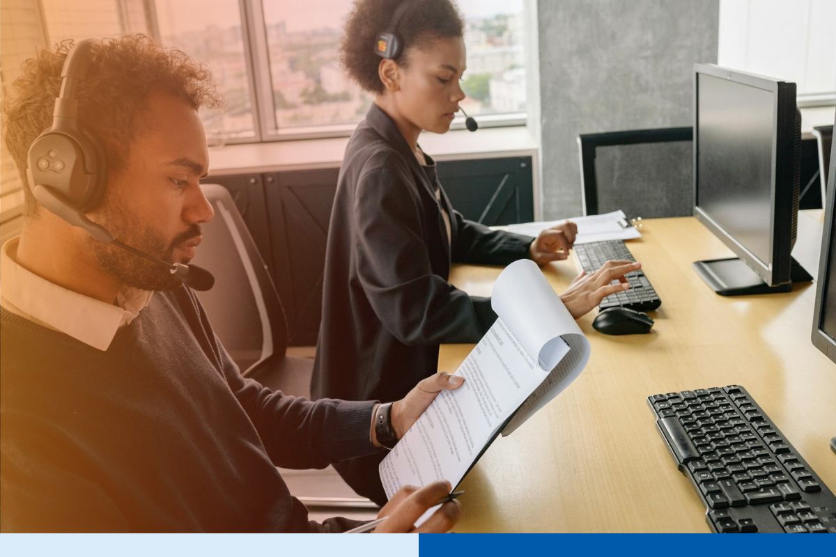 Payroll outsourcing professionals analyzing payroll data and employee compensation records in a finance operations office.