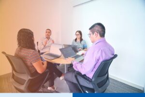  Offshore engineering team collaborating during a knowledge transfer session in a modern Latin America office