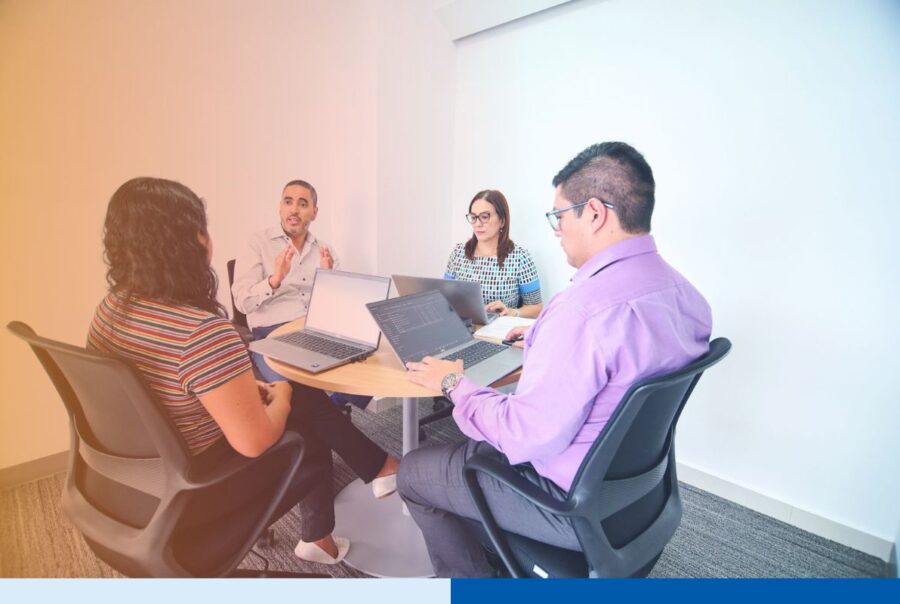 Offshore engineering team collaborating during a knowledge transfer session in a modern Latin America office