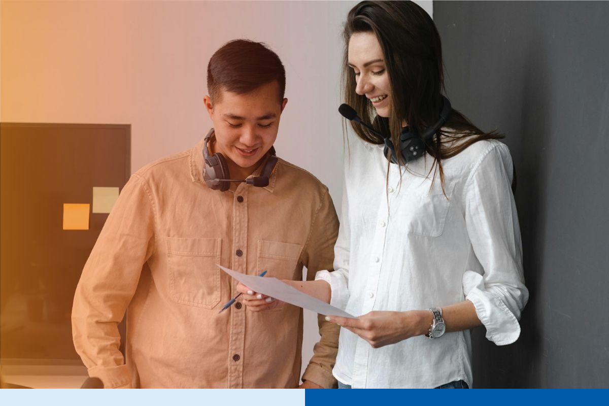 Manager and offshore team member working together on a shared document, the direct collaboration that solves common problems with outsourcing.