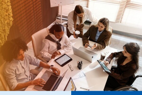 Operations team reviewing performance charts around a conference table, representing offshore team oversight and audit