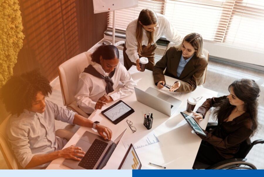 Operations team reviewing performance charts around a conference table, representing offshore team oversight and audit
