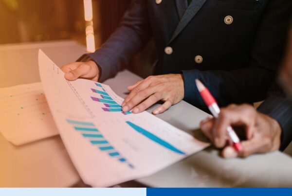 Executive reviewing low turnover BPO vendor retention data during due diligence